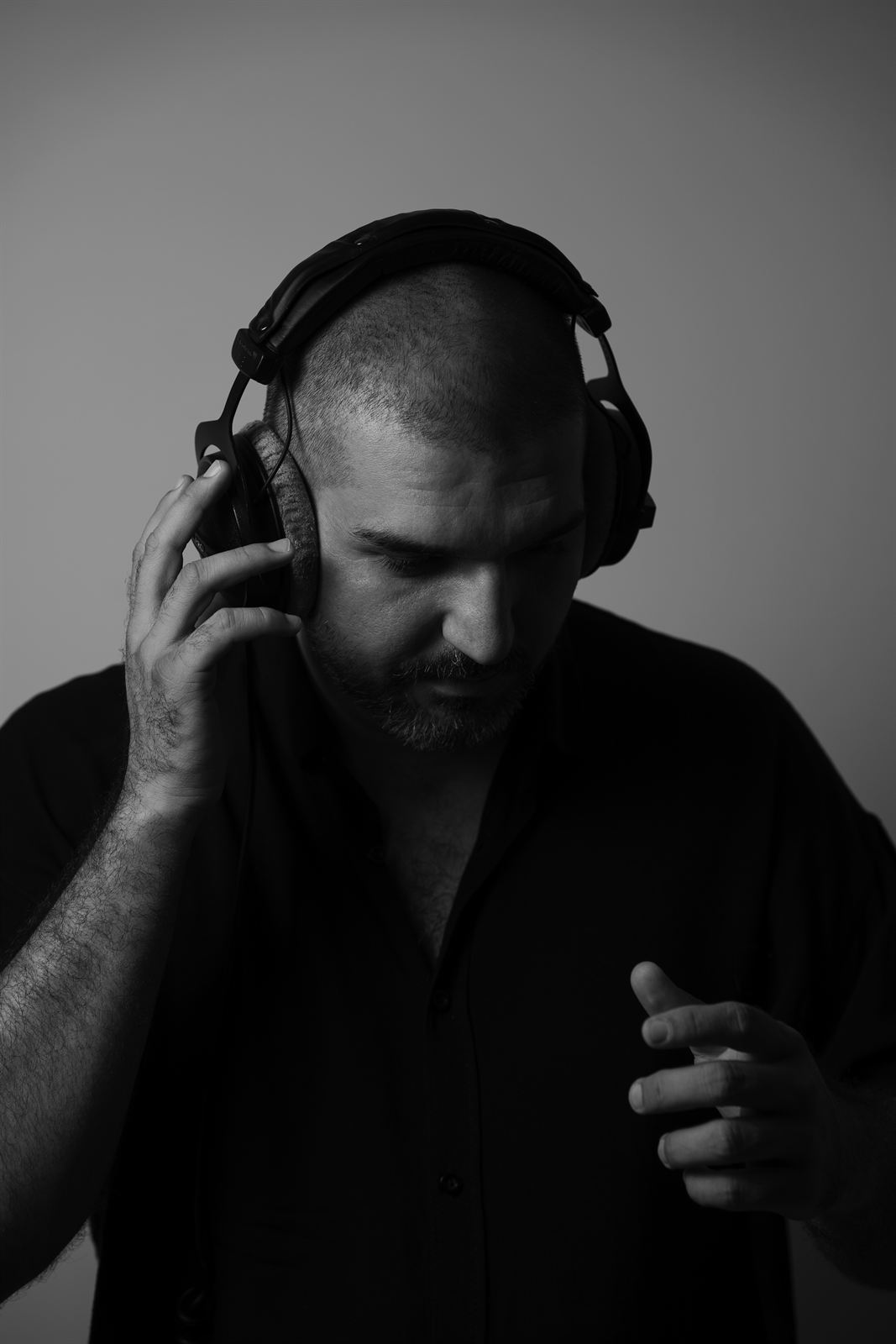 Bruce Nemeth in headphones, eyes down, listening