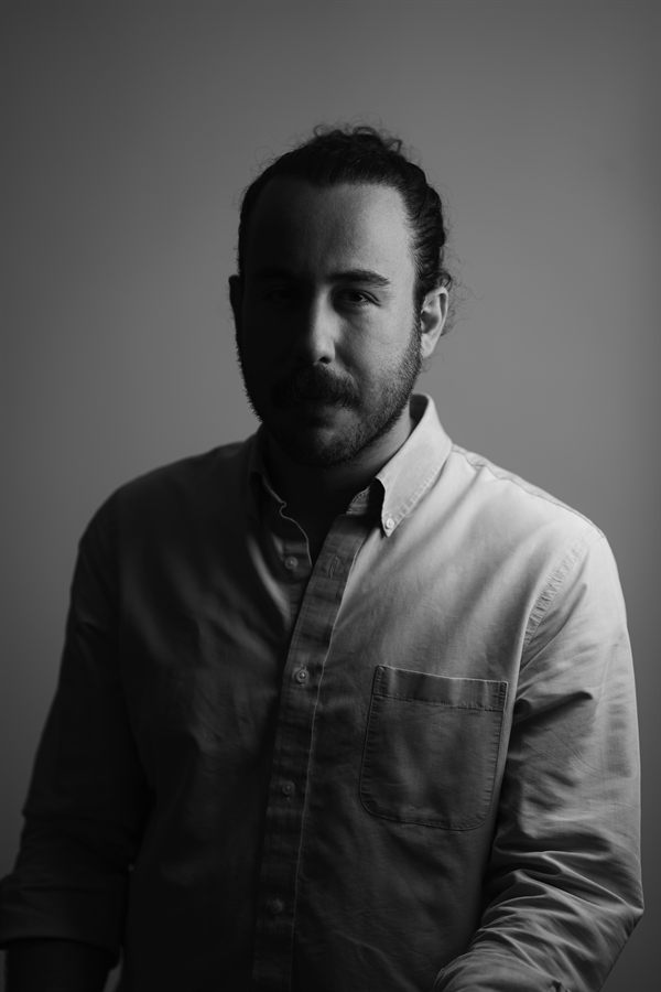 Shayan, in a half-lit studio portrait